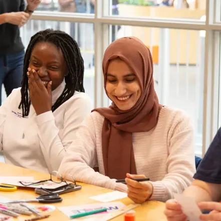 Two Smith students laugh during a workshop at ZineFest